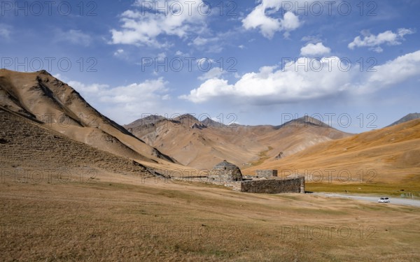 Historic caravanserai Tash Rabat from the 15th century, with yellow hills, Atbashy district in the