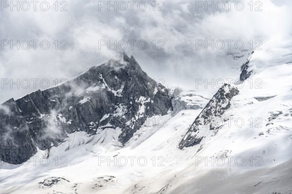 Mountain landscape of rock and ice, rocky peak between glacial ice on the Waxeggkees glacier,