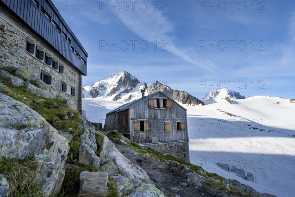 Old and new mountain hut Refuge Albert 1er, high alpine mountain landscape, summit of the Aiguille
