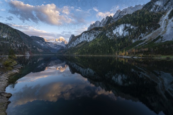 The Vordere Gosausee lake in autumn with a view of the Dachstein mountain range. The Gosaukamm on