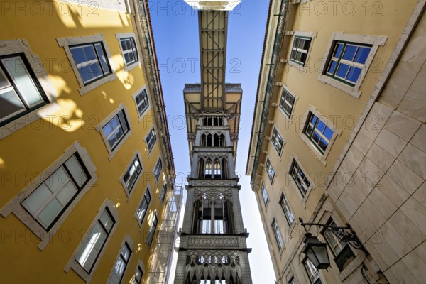 View from below of the Santa Justa Lift, an historical elevator in Lisbon, contrasting with the