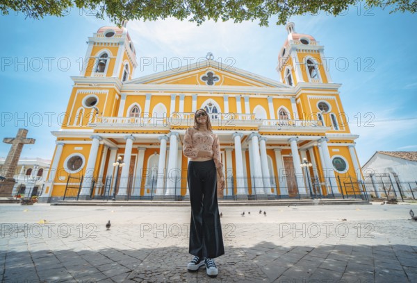 Portrait of a beautiful tourist girl in front of the cathedral in Granada, Nicaragua. Portrait of