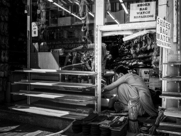 Black and white photography, shoe shops and craftsmen in Al Fahidi neighbourhood, Dubai, United