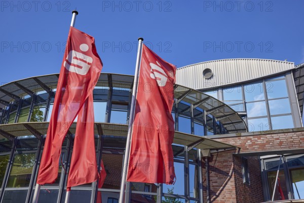 Flags with the Sparkasse logo in front of the Sparkasse Stade-Altes Land branch in Stade, Hanseatic