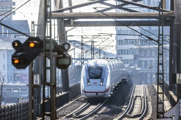 ICE en route on a railway bridge with tracks and signalling system. Mannheim, Baden-Württemberg,