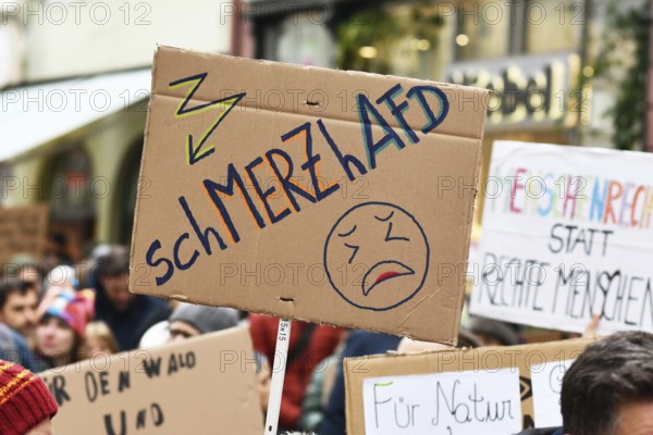 Heidelberg, Germany - February 12th 2025: Person holding up sign about CDU politian Merz and right