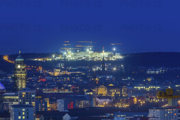 City centre of Dresden at blue hour, on the horizon the illuminated construction site of Infineon,