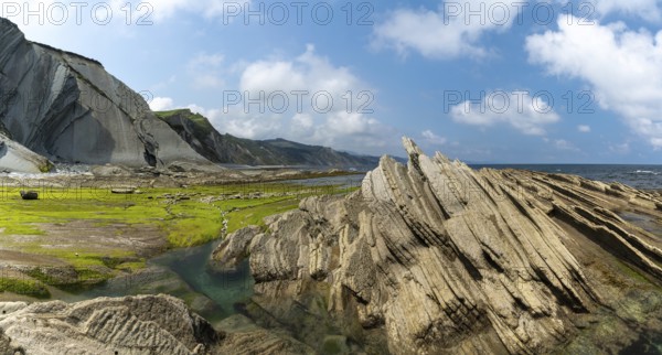 A panorama view of the Flysch rock formations and cliffs with tidal pools on the Basque Country