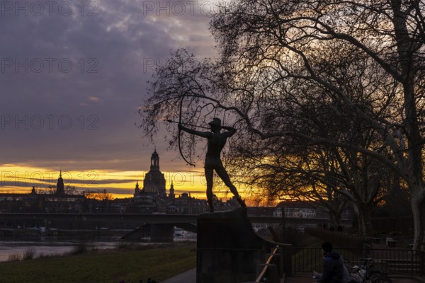 Sunset on the banks of the Elbe in Dresden, with a view of the historic old town and the archer,