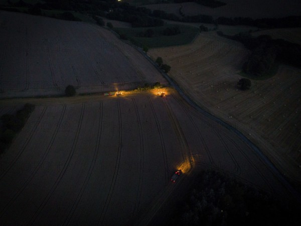 A combine harvester harvests a grain forest. When it is harvest time, the grain must also be