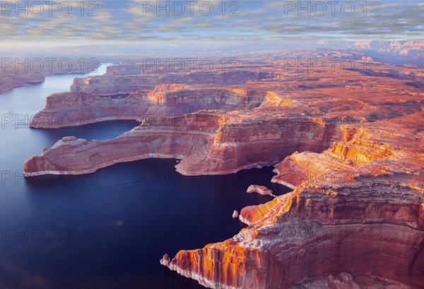 Landscape under the wing of an airplane. U.S. The coast of Lake Powell is cut by narrow canyons.