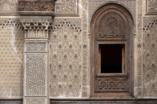 Fes, Morocco, April 04, 2023, Rich decorated facade in the courtyard of the Medersa Attarine in