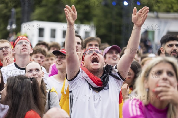 Football fans in the fan zone at the Brandenburg Tor during the quarter-final match between Germany