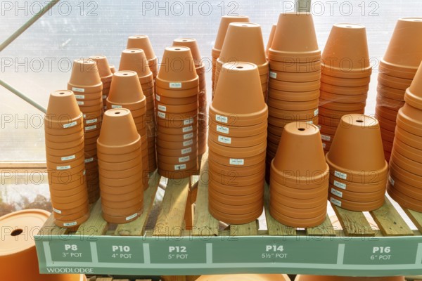 Variety of sizes of clay flower pots on display in at Swanns Nursery garden centre, Suffolk,