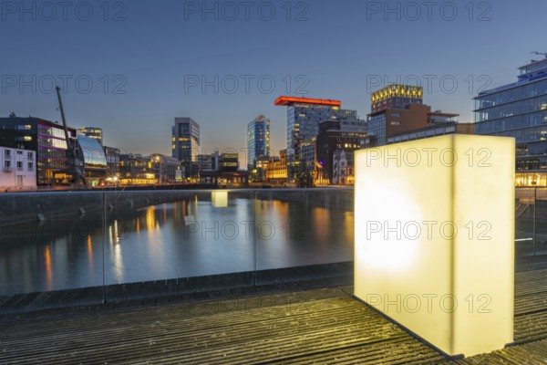 Illuminated pedestrian bridge over the harbour basin in the Media Harbour, Düsseldorf, North