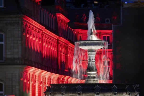 Court of honour on Schlossplatz. The New Palace and fountain are illuminated. Stuttgart,