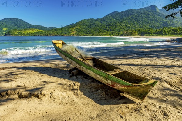 Primitive wooden fishing canoe on the sands of Castelhanos beach in Ilhabela, Castelhanos beach,