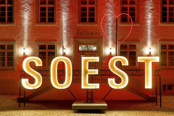 Illuminated town hall with Soest lettering in the evening at the Winterstrahlen Festival of Lights