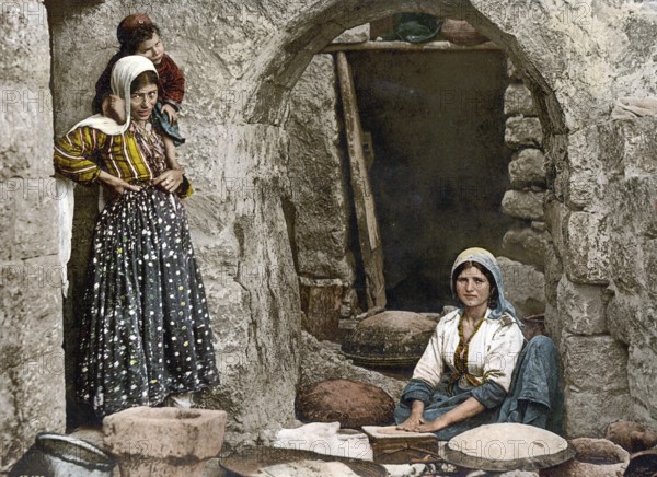 Peasant woman baking bread, Syria, Historical, digitally restored reproduction from a 19th century