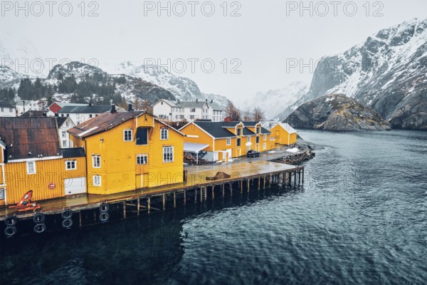 Panorama of Nusfjord authentic fishing village with yellow rorbu houses in Norwegian fjord in