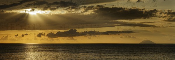 Sunset on the beach of Tropea with the Aeolian (Liparic) Islands and the volcanic island of