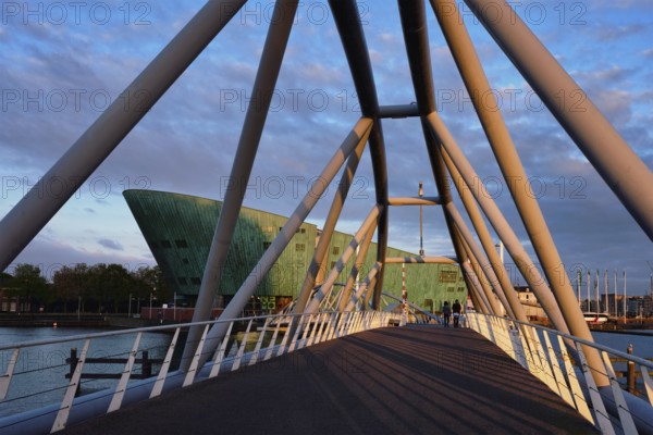 AMSTERDAM, NETHERLANDS, MAY 9, 2017: NEMO Science museum and Mr. J. van der Veldebrug bridge. It is
