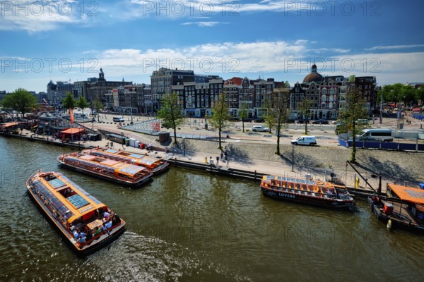 AMSTERDAM, NETHERLANDS, MAY 9, 2017: Aerial view of Amsterdam canal with tourist boats near