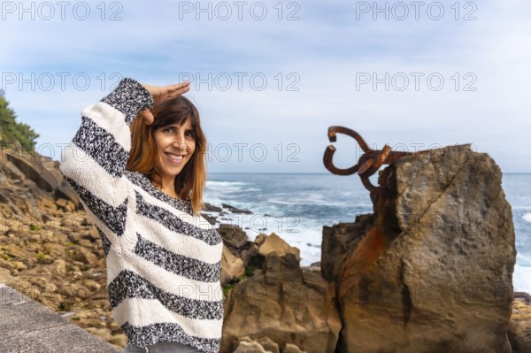 A young European tourist visiting the Peine del Viento in San Sebastián. Province of Gipuzkoa,