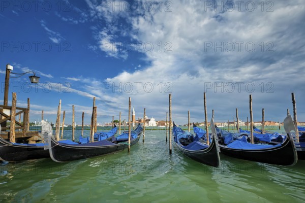 Gondolas and in lagoon of Venice by Saint Mark (San Marco) square with San Giorgio di Maggiore