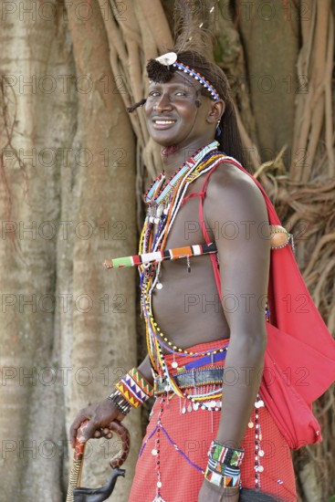 Maasai warrior wearing traditional dress, near Enkutoto, Masai Mara, Rift Valley Province, Kenya,