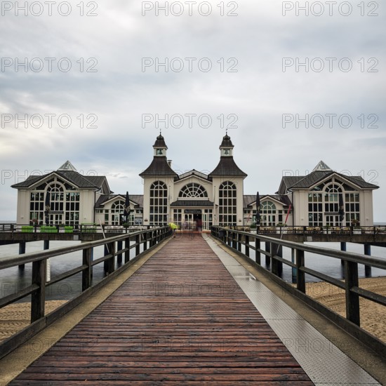 Sellin pier with individual tourists, rainy weather on the Baltic Sea, long exposure, Baltic Sea