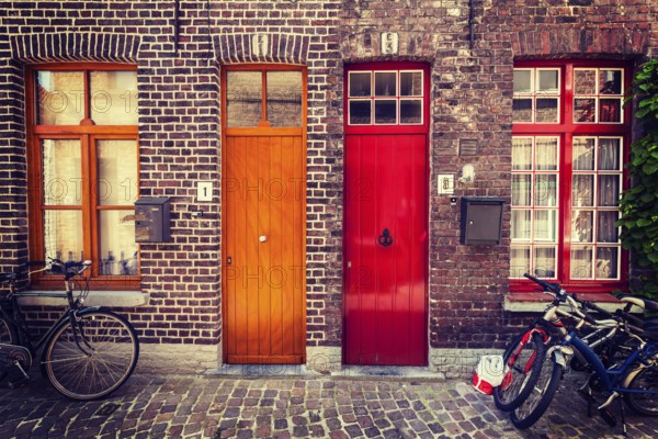 Doors of old houses and bicycles in european city. Bruges Brugge, Belgium, Europe