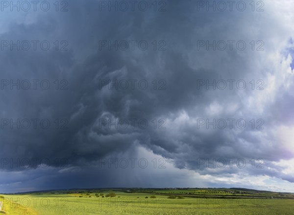 Thunderstorm cell with rainbow over fields near Krebs in the Osterzgebirge, Krebs, Saxony, Germany,
