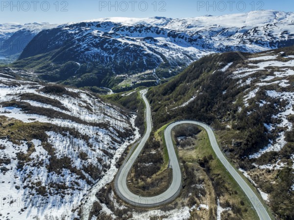 Aerial view of mountain road over the Haukelifjell, winding down to Roeldal, early spring, Norway,