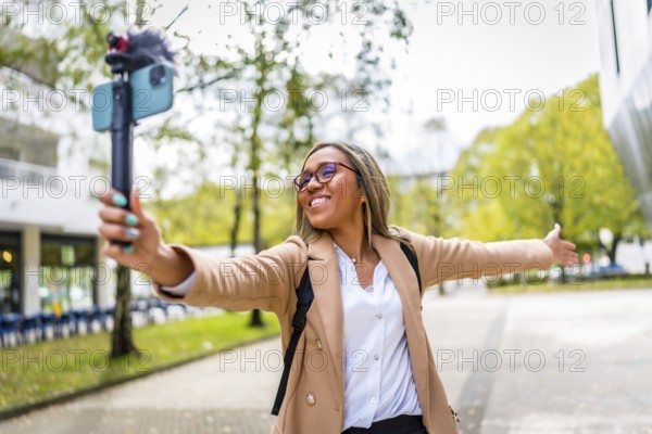 Latin female content creator opening arms showing a city to the audience while recording a video