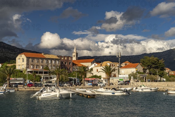 Town view with harbour and church Crkva Marija Pomocnica in Orebic, Peljesac peninsula, Croatia,