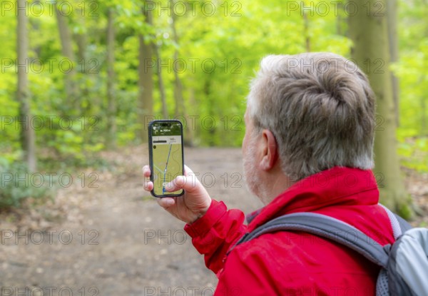 Symbolic image Hiking with smartphone and hiking app, navigation on hiking trails, digital hiking