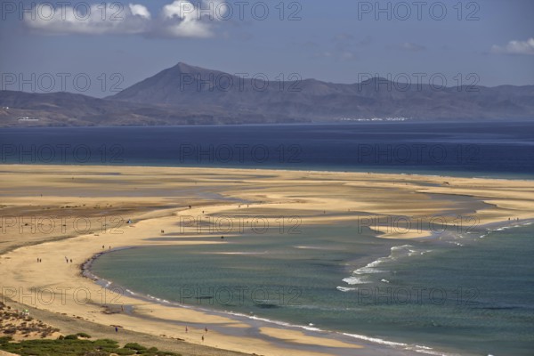Endless beach Playa Risco del Paso, Playa de Sotavento with gentle waves, surrounded by mountains,