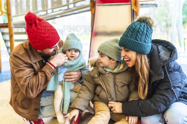 Cheerful parents are enjoying wintertime with their children at an indoor playground, creating a
