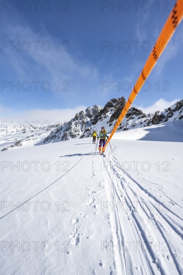 Ski tourer with rope, rope team on the Vadret da Porchabella glacier on the ascent to the summit of