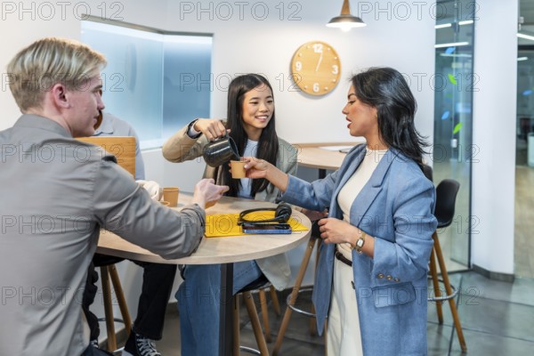 Businesswomen and businessmen enjoying a coffee break in a modern coworking office, fostering