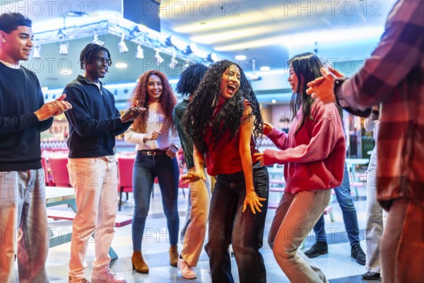 Cheerful multi ethnic friends dancing joyfully and enjoying their time together at the lively