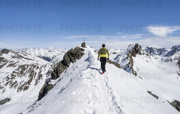 Mountaineer on the summit of the Scalettahorn in winter, Graubünden Haute Route, Albula Alps,