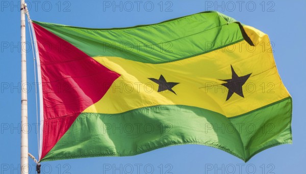 The flag of the Democratic Republic of Sao Tome, Africa, flutters in the wind, isolated against a