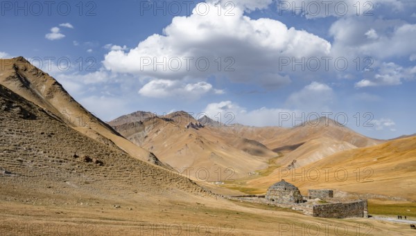 Historic caravanserai Tash Rabat from the 15th century, with yellow hills, Atbashy district in the