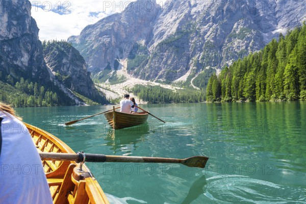 Tourists enjoying a boat trip on the stunning lake braies, surrounded by the breathtaking scenery