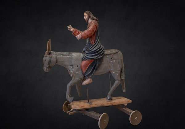 Christ on the palm donkey, on a dark background, wooden figure from around 1400, Museum Bezau,