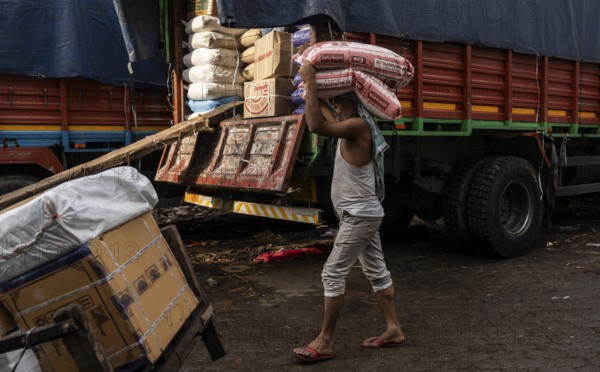 GUWAHATI, INDIA - MAY 1: Labourers carries goods in a wholesale market, in Guwahati, India, on May