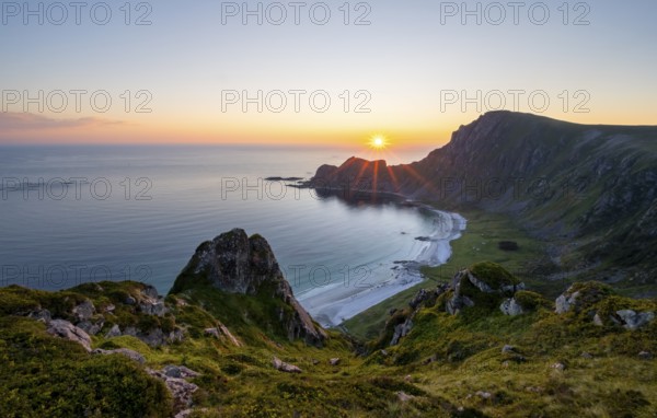 View of coastal landscape at sunset, cliffs and summit of Måtind or Måtinden, Høyvika beach and