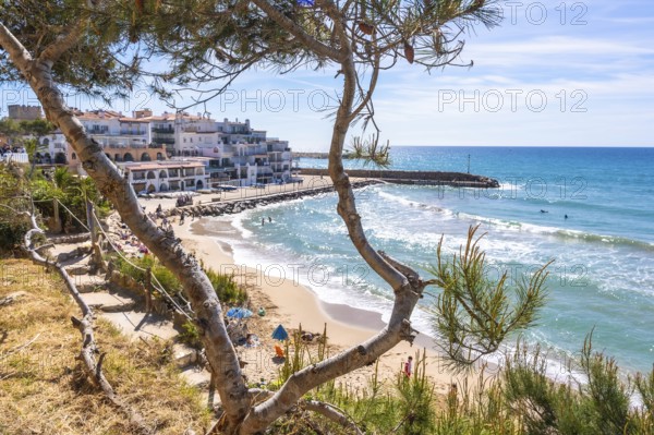 Scenic view of the mediterranean sea from cami de ronda, featuring white buildings, sandy beach,
